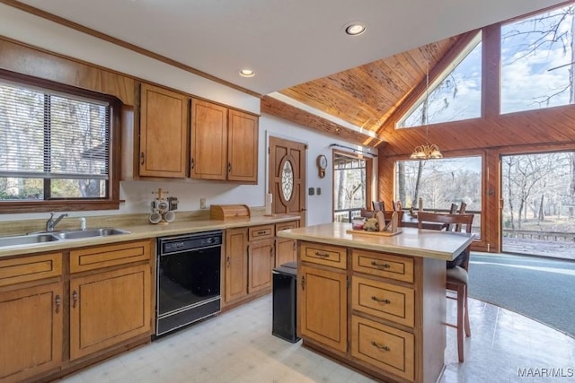 kitchen with a breakfast bar, sink, a chandelier, a center island, and black dishwasher