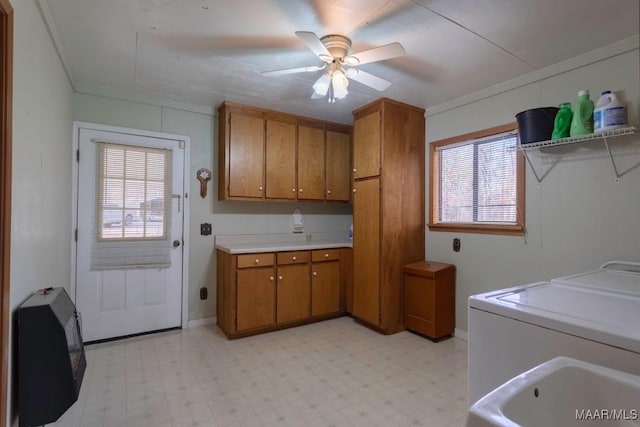 laundry room featuring cabinets, washing machine and clothes dryer, ceiling fan, and heating unit