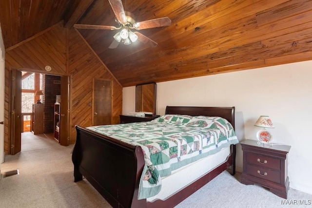 bedroom featuring wood walls, light colored carpet, lofted ceiling with beams, wooden ceiling, and ceiling fan