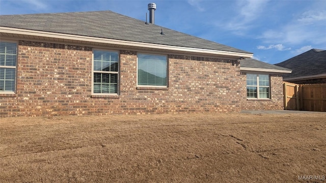 view of property exterior with a yard