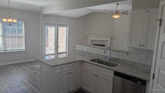 kitchen featuring sink, white cabinetry, vaulted ceiling, dishwasher, and kitchen peninsula