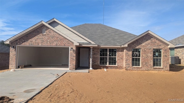 view of front facade with central AC unit and a garage