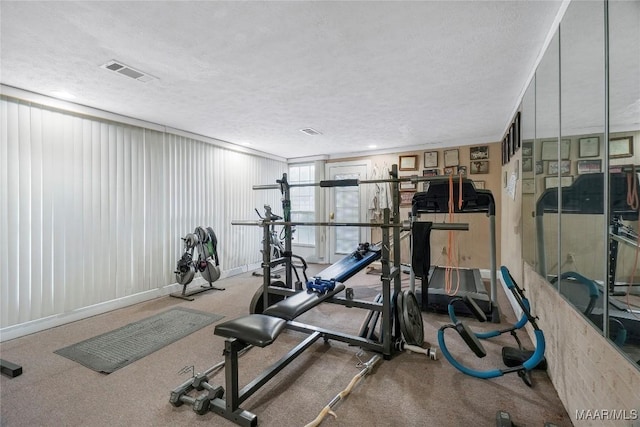 workout room featuring a textured ceiling