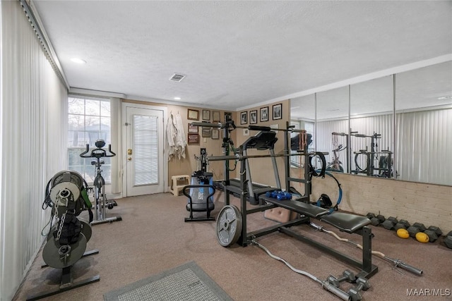 workout area featuring a textured ceiling