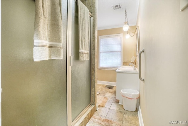 bathroom featuring vanity, tile patterned floors, and a shower with shower door