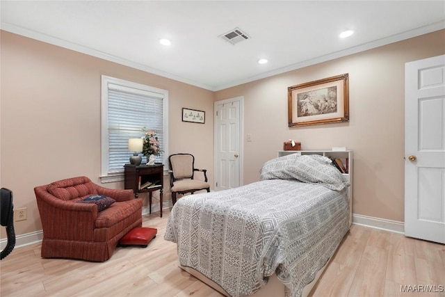 bedroom featuring crown molding and light hardwood / wood-style floors