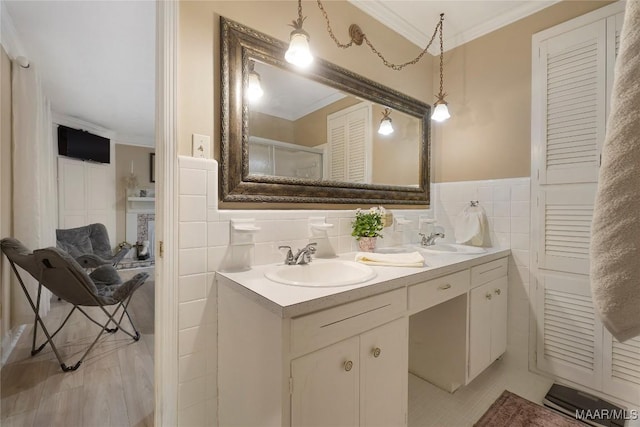 bathroom featuring crown molding, tile walls, and vanity