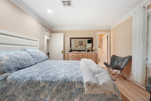 bedroom featuring light hardwood / wood-style flooring and ornamental molding