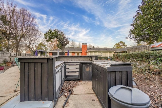 view of patio / terrace featuring sink and an outdoor kitchen