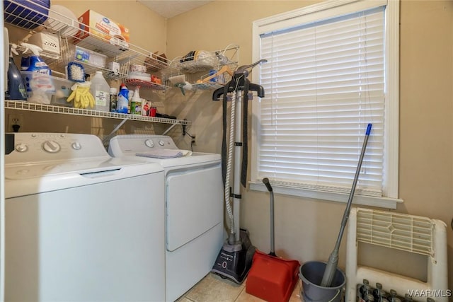 laundry room featuring washer and dryer and light tile patterned floors