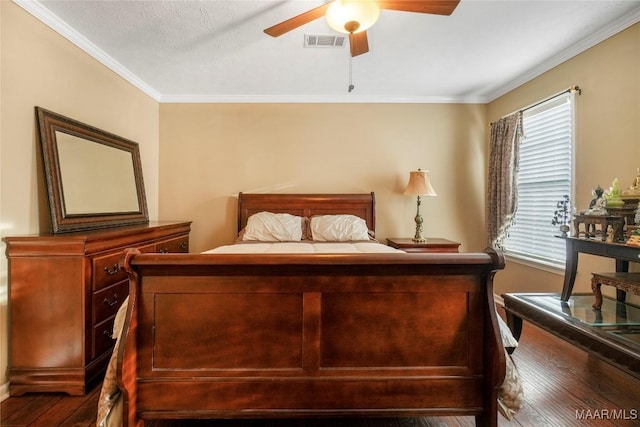 bedroom featuring crown molding, dark wood-type flooring, and ceiling fan