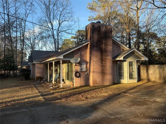 view of property exterior featuring covered porch