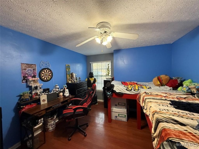 bedroom with ceiling fan, a textured ceiling, and dark hardwood / wood-style flooring