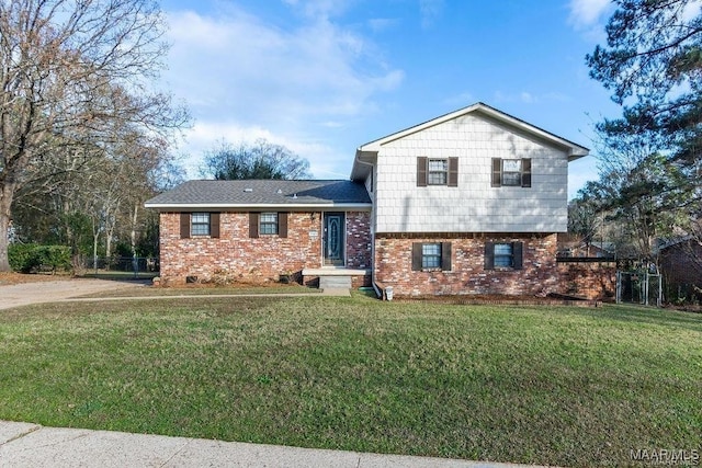 tri-level home with a front lawn