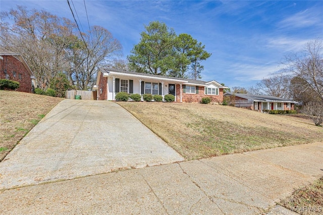 single story home with a front yard and a porch