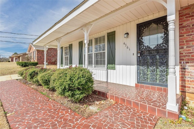 view of exterior entry with a porch