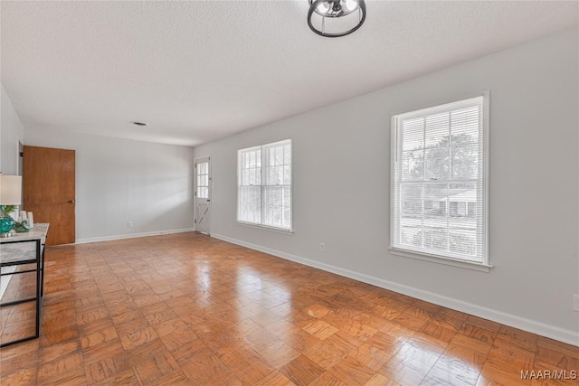 unfurnished living room featuring a textured ceiling