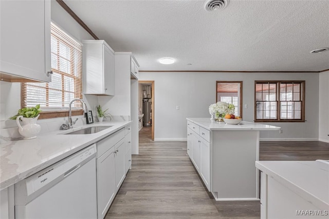 kitchen with sink, ornamental molding, white cabinets, and dishwasher