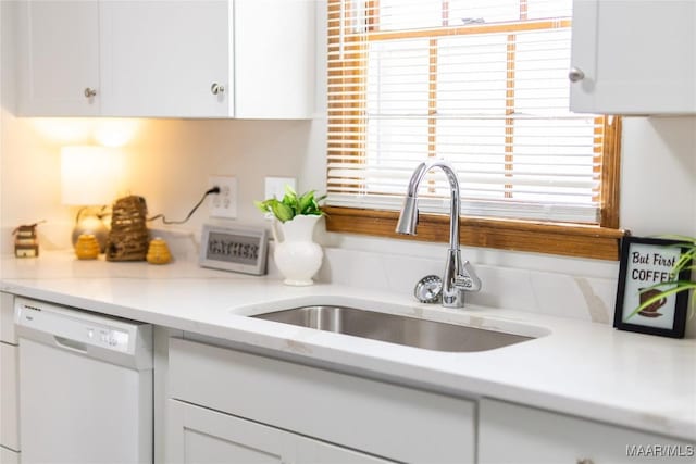 kitchen featuring white cabinetry, sink, and white dishwasher