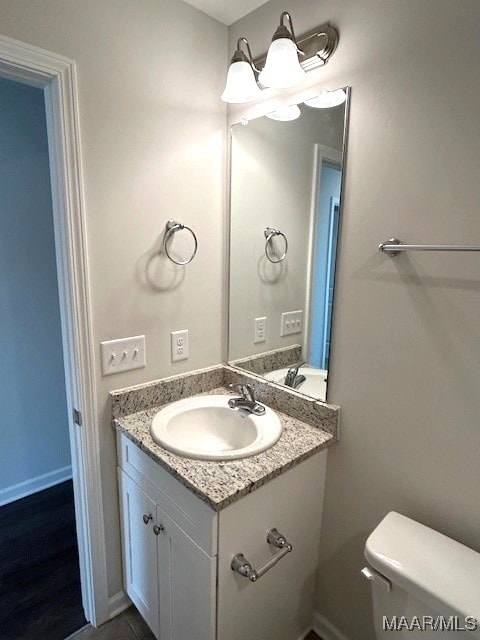 bathroom featuring vanity and toilet