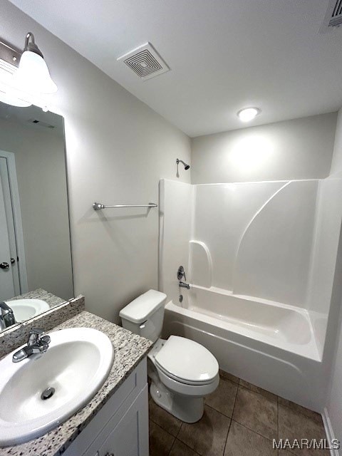 full bathroom with shower / washtub combination, vanity, tile patterned floors, and toilet