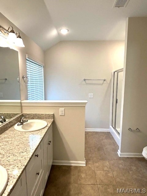 bathroom with lofted ceiling, vanity, tile patterned flooring, and a shower with shower door