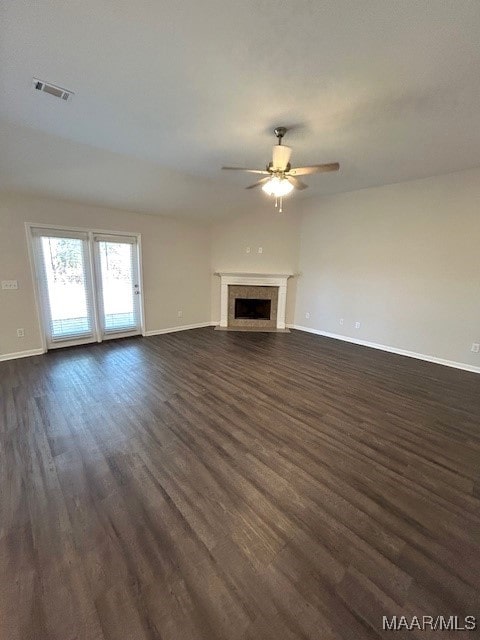 unfurnished living room with ceiling fan and dark hardwood / wood-style flooring