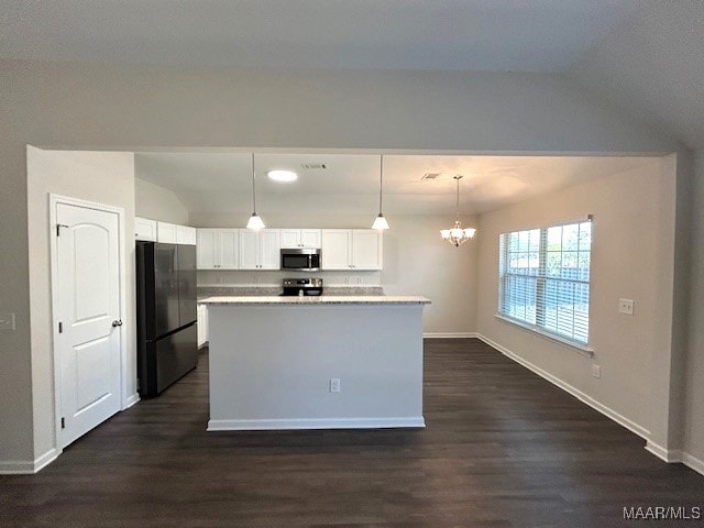 kitchen featuring pendant lighting, appliances with stainless steel finishes, dark hardwood / wood-style floors, white cabinets, and a kitchen island