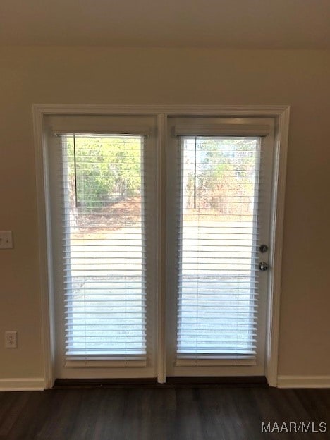 entryway with dark hardwood / wood-style flooring