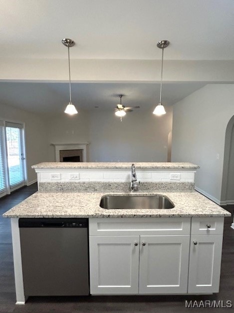 kitchen with sink, decorative light fixtures, stainless steel dishwasher, and white cabinets