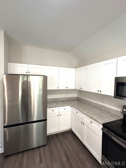 kitchen featuring white cabinetry, appliances with stainless steel finishes, dark hardwood / wood-style floors, and lofted ceiling