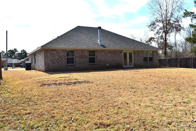 back of property featuring a yard