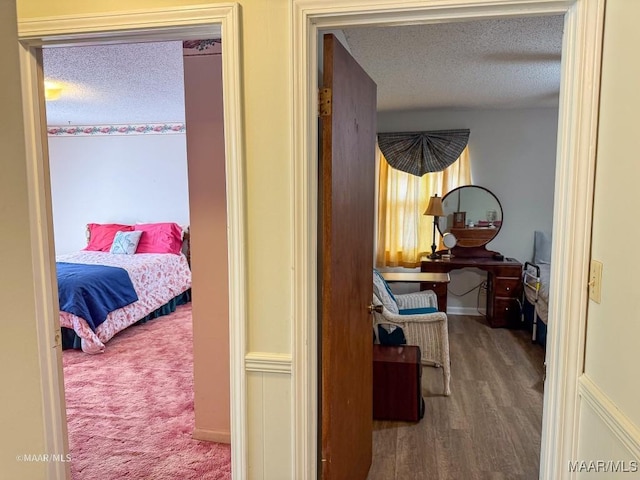 bedroom featuring hardwood / wood-style floors and a textured ceiling