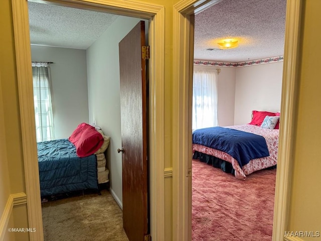 carpeted bedroom with a textured ceiling