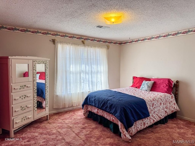 carpeted bedroom with a textured ceiling