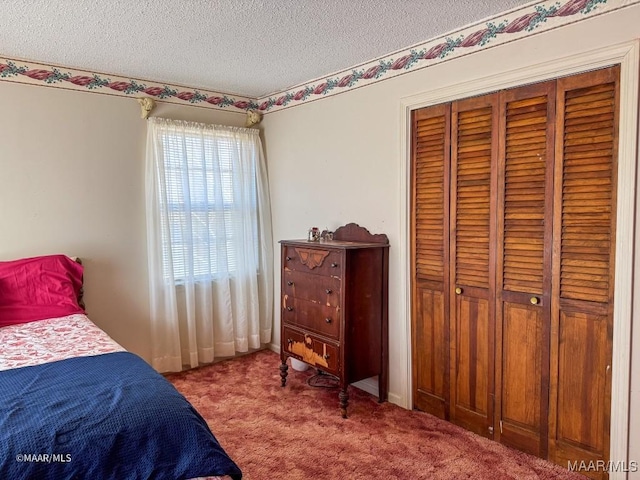 bedroom with light colored carpet, a textured ceiling, and a closet