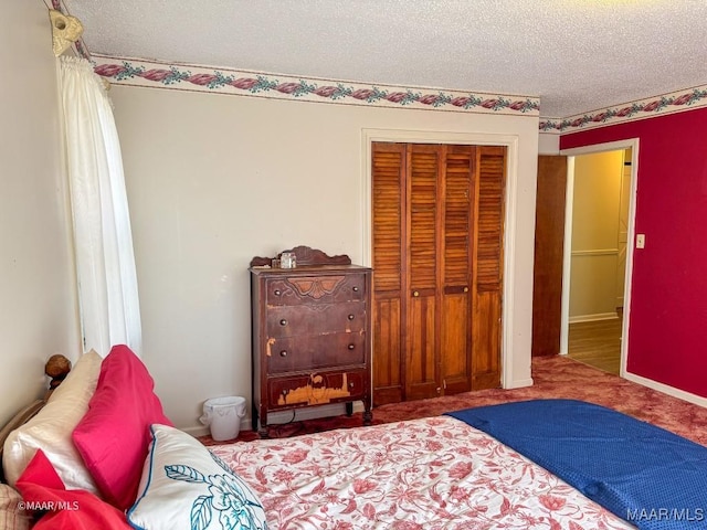 carpeted bedroom with a textured ceiling and a closet