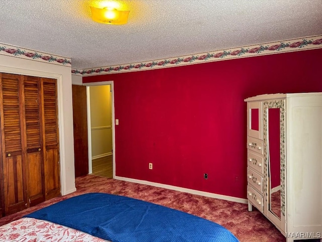 unfurnished bedroom with carpet, a textured ceiling, and a closet