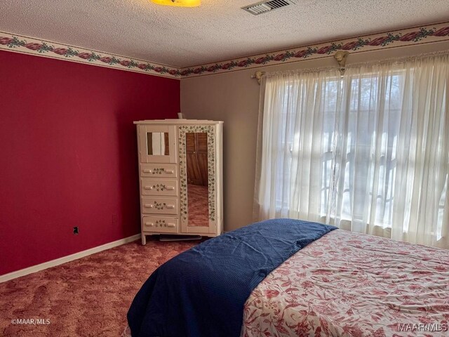 bedroom with a textured ceiling and carpet