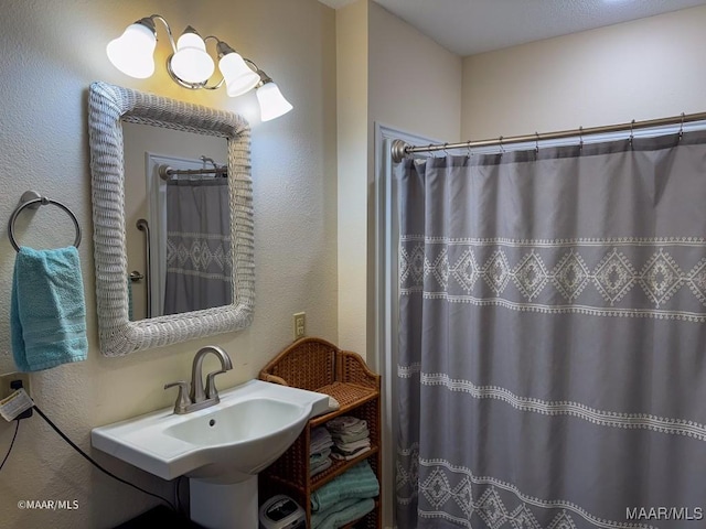 bathroom with a shower with curtain and sink