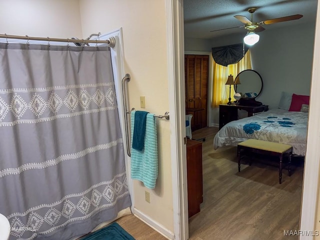 bathroom with hardwood / wood-style flooring and ceiling fan