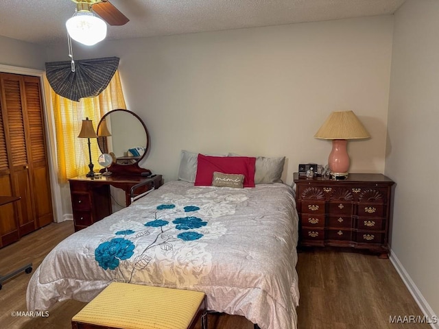 bedroom featuring dark wood-type flooring, a textured ceiling, and a closet