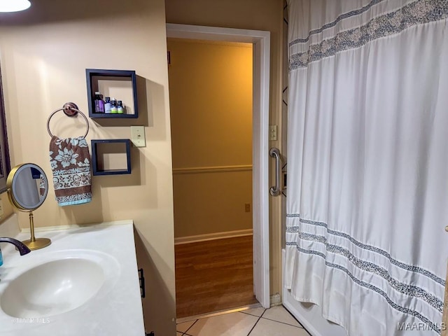 bathroom featuring sink, tile patterned floors, and shower / tub combo with curtain