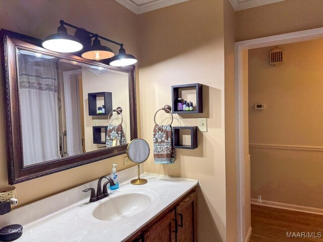 bathroom with vanity, wood-type flooring, and crown molding