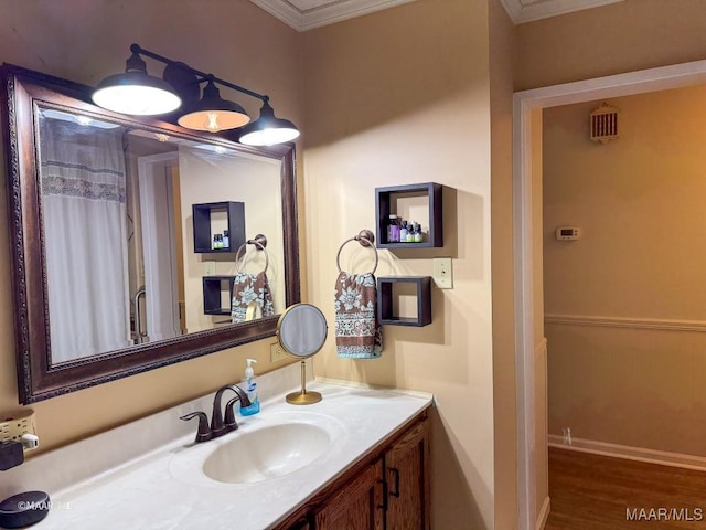 bathroom featuring vanity, wood-type flooring, and ornamental molding