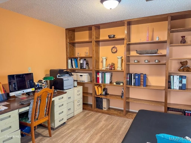 office area featuring a textured ceiling and light wood-type flooring