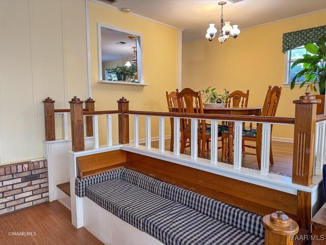 interior space with a notable chandelier, light hardwood / wood-style flooring, and ornamental molding