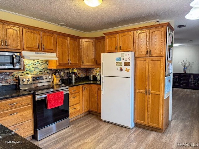 kitchen with appliances with stainless steel finishes, backsplash, ornamental molding, light hardwood / wood-style floors, and a textured ceiling