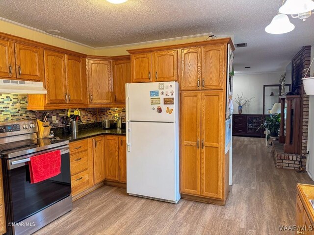 kitchen with backsplash, white refrigerator, light hardwood / wood-style floors, a textured ceiling, and stainless steel range with electric cooktop