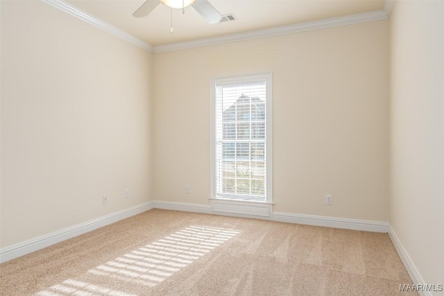 carpeted spare room featuring ceiling fan and ornamental molding